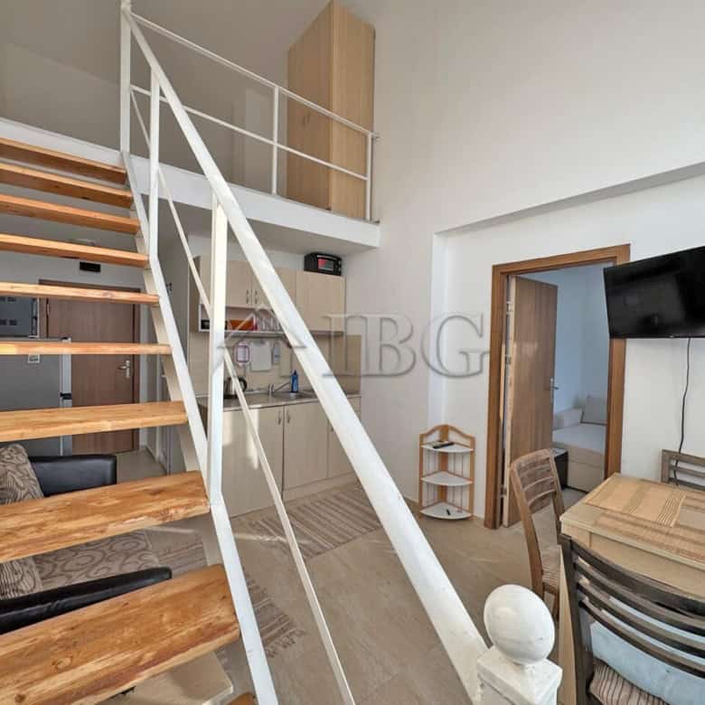 Bright, airy living space with wooden stairs and contemporary furnishings.