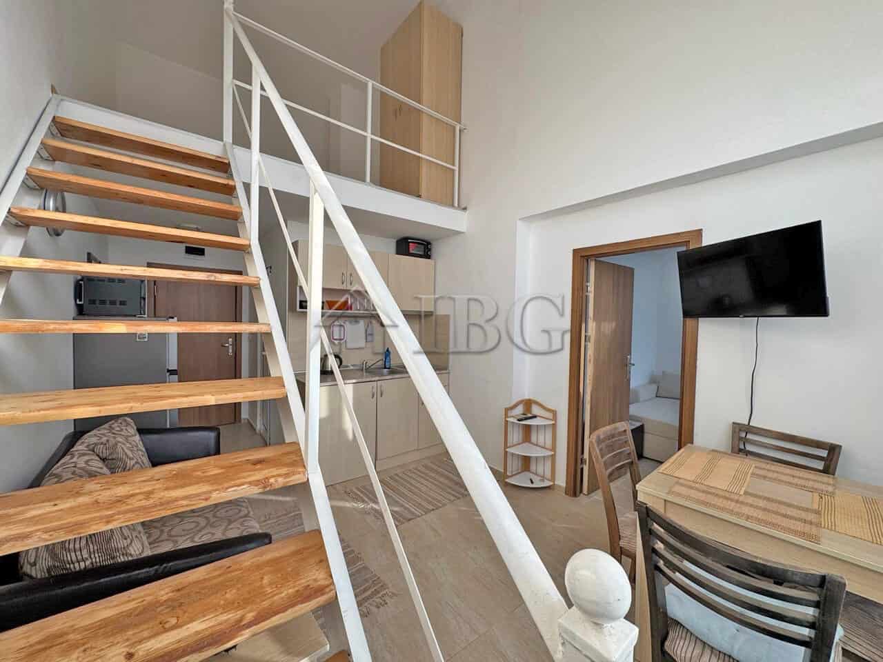 Bright, airy living space with wooden stairs and contemporary furnishings.