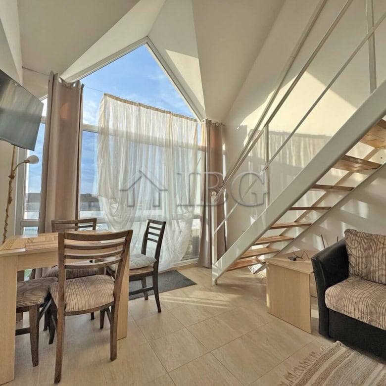 Bright living area with large windows and modern furnishings.