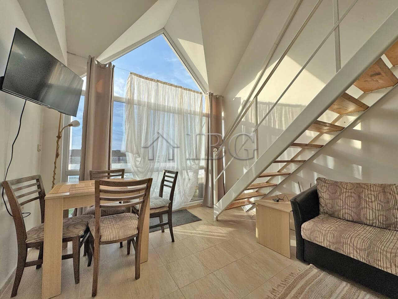 Bright living area with large windows and modern furnishings.