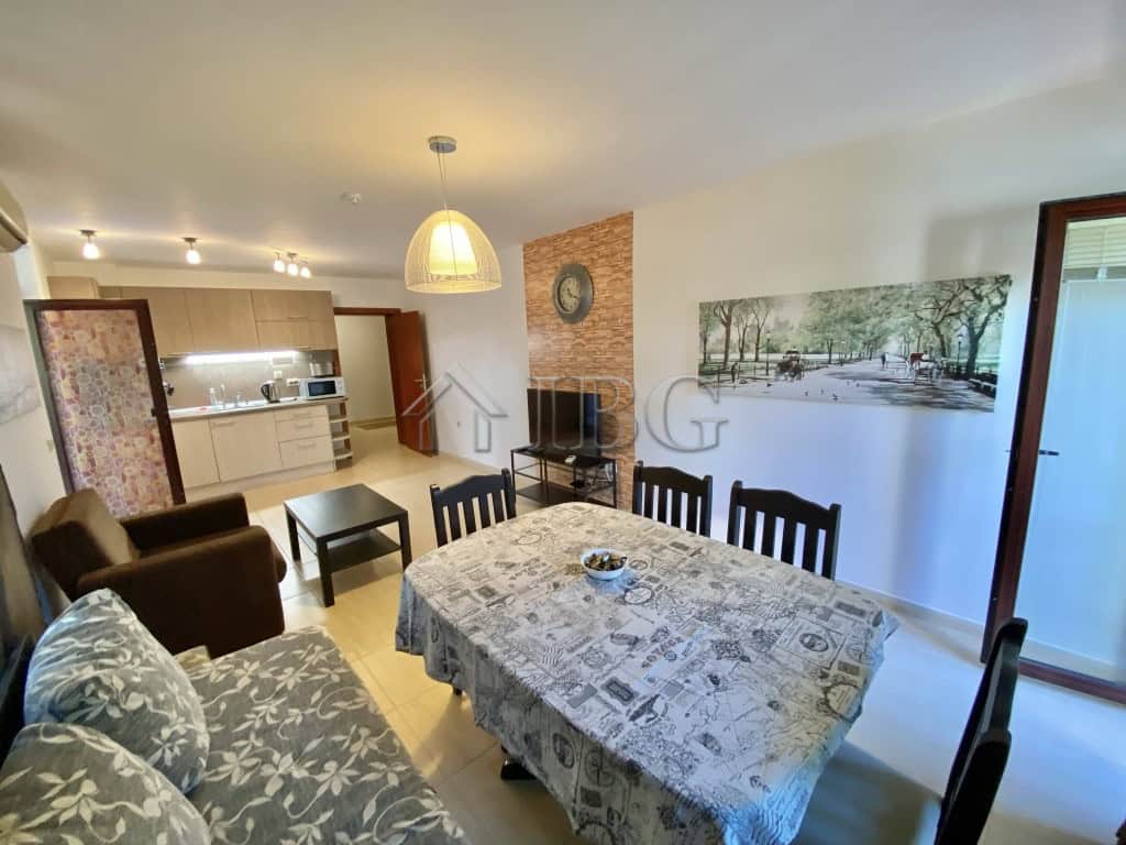 Spacious apartment living room with dining table, sofa, and modern decor in Sveti Vlas.