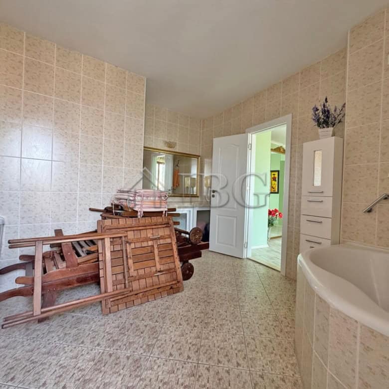 Spacious bathroom with bathtub and storage in a beachfront apartment at Grand Hotel Sveti Vlas.