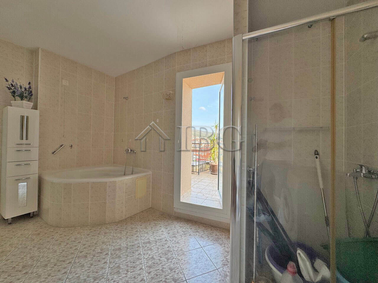 Spacious bathroom with bathtub and shower in a beachfront apartment at Grand Hotel Sveti Vlas.