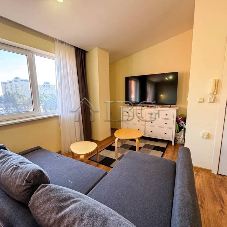 Bright living room with sea view, modern furniture, and large windows in Sunny Beach apartment.
