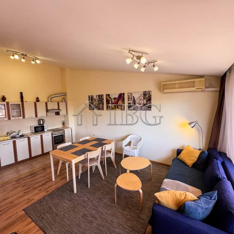 Modern 2-bedroom apartment with sea view, open-plan kitchen, and cozy living area in Sunny Beach.