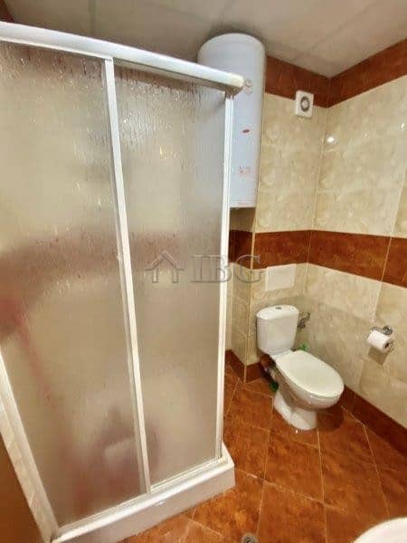 Furnished studio bathroom with shower, toilet, and water heater in Nessebar Fort Club.