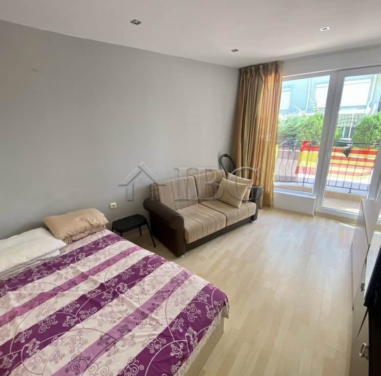 Bright living room in Sveti Vlas apartment with balcony view.
