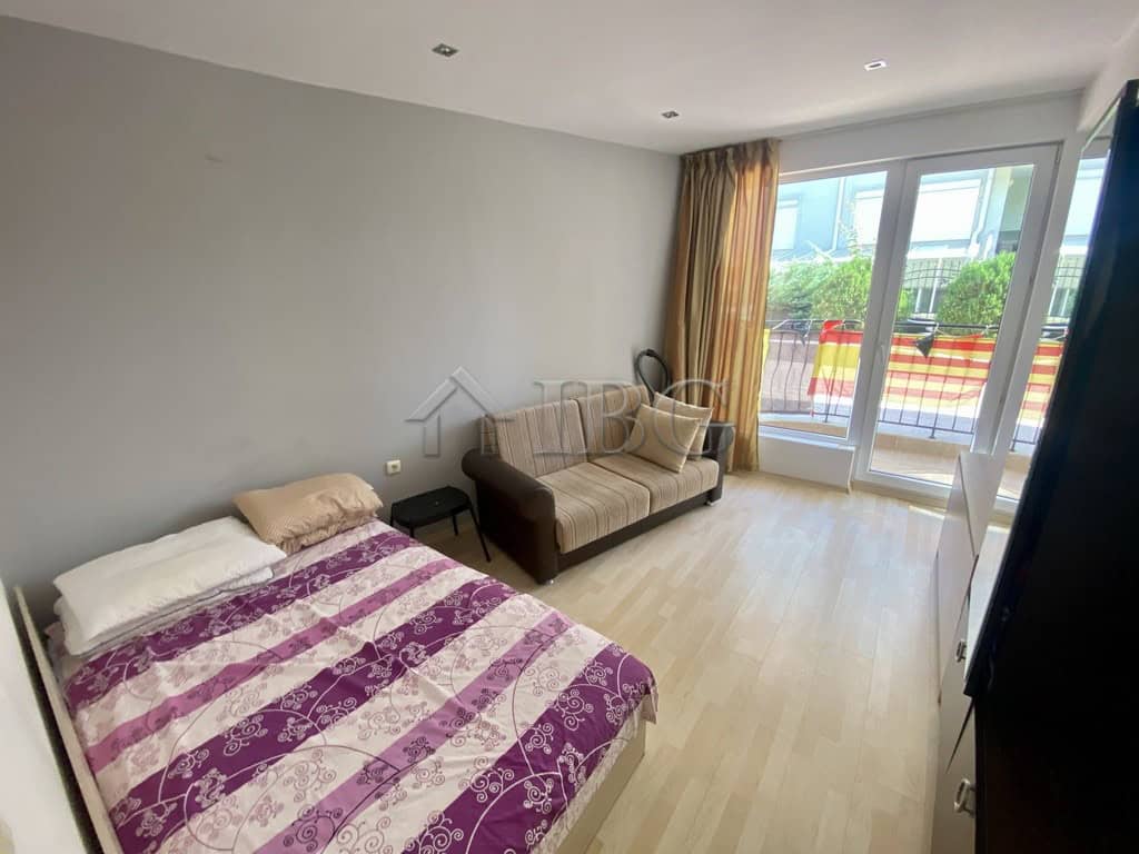 Bright living room in Sveti Vlas apartment with balcony view.