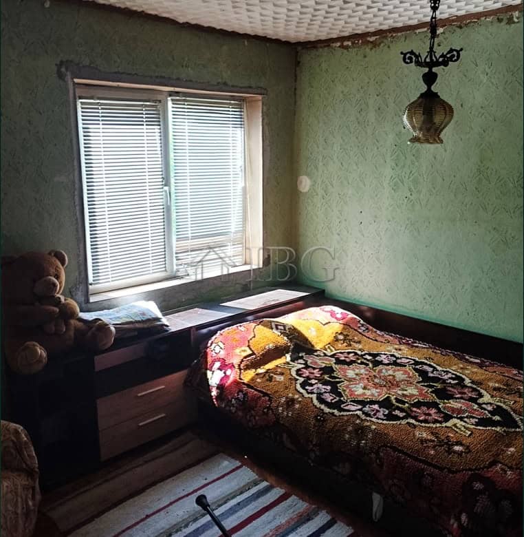 Bright bedroom with large window and vintage decor.