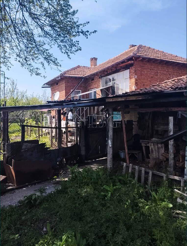 Two-storey brick house with large garden and outdoor storage area. Prime edge-of-village location of.