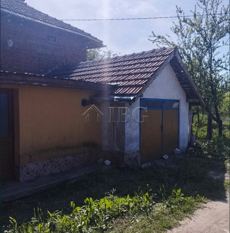 Two-storey house with a large garden in a peaceful village setting.