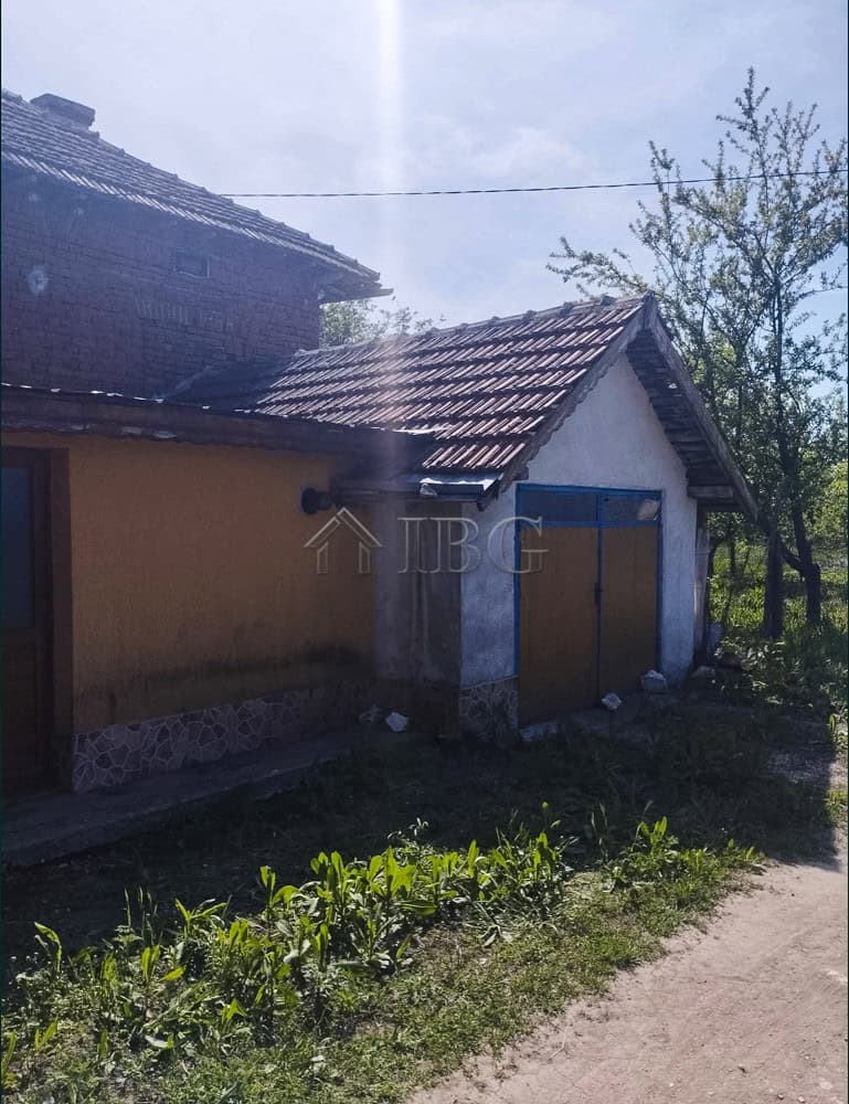 Two-storey house with a large garden in a peaceful village setting.
