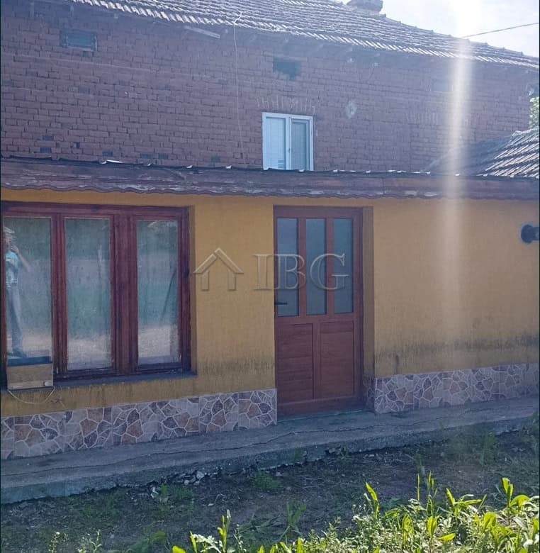 Two-storey house with a large garden in a peaceful village setting.