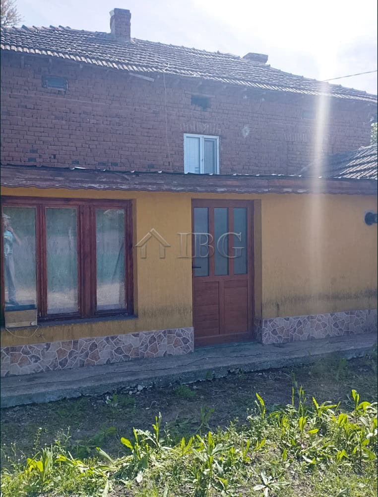 Two-storey house with a large garden in a peaceful village setting.
