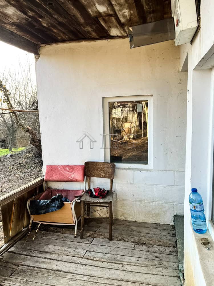 House at the Edge of Brestovitsa Village, Ruse Area – Large Garden, Garage and Outbuildings Outdoor porch with chairs and water bottle in Brestovitsa village, Ruse area.