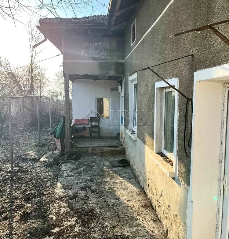 House exterior with a large garden, garage, and outbuildings in Brestovitsa village, Ruse area.