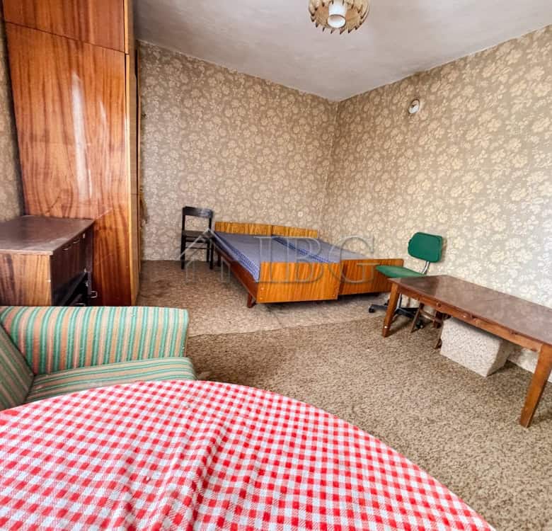 Interior of a 3-bedroom house with vintage furniture and patterned wallpaper in Shtraklevo Village.