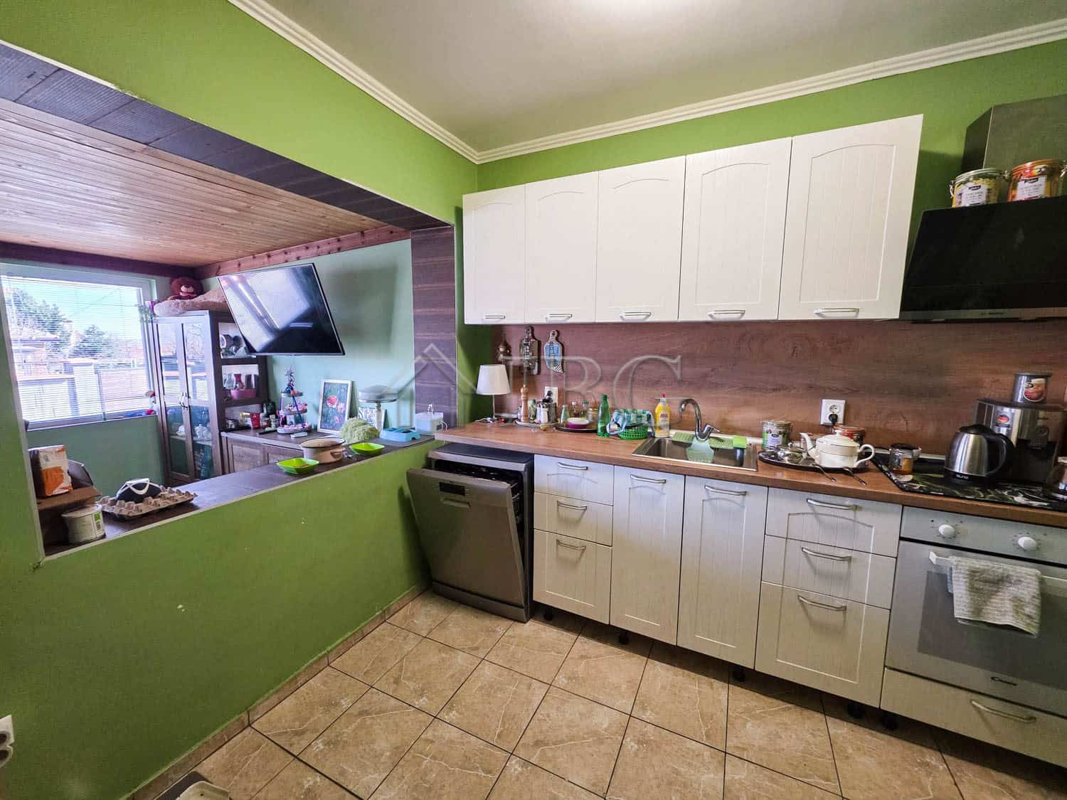 Bright kitchen with white cabinets and modern appliances, perfect for family living close to Sunny B.