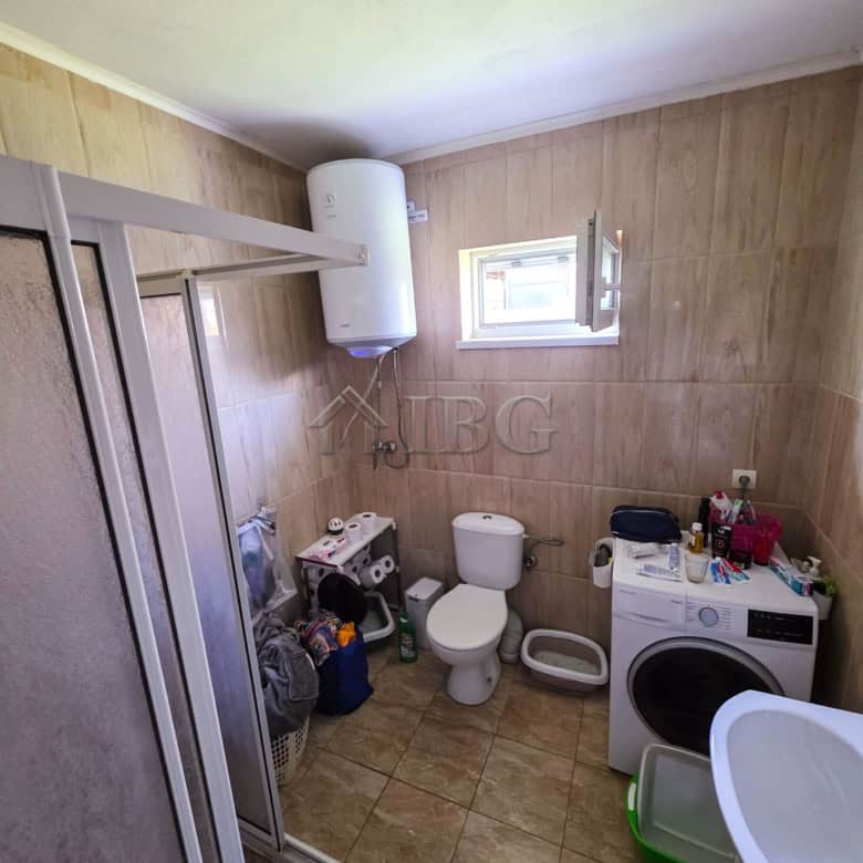 Bright bathroom in a detached house with a garden, featuring modern fixtures and a small window for.