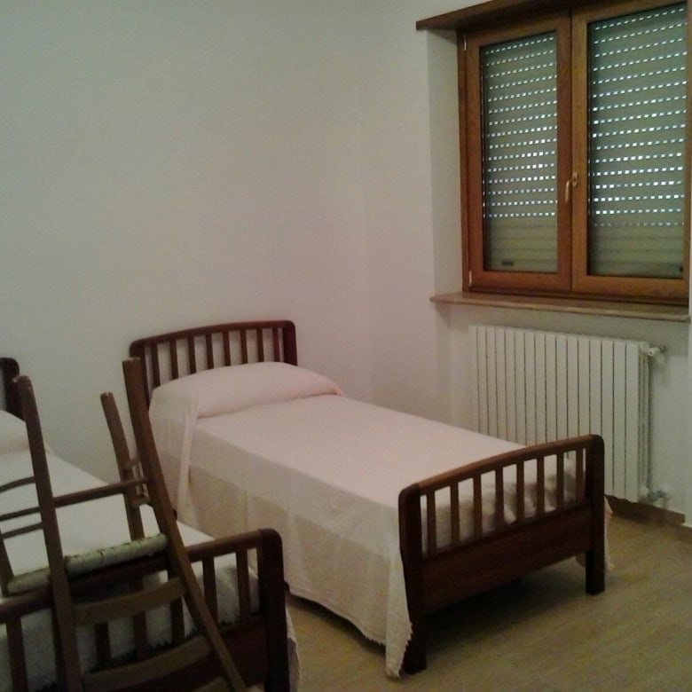 Interior view of a 3-bedroom house in Orsara di Puglia, Italy, with simple furnishings and a large w.
