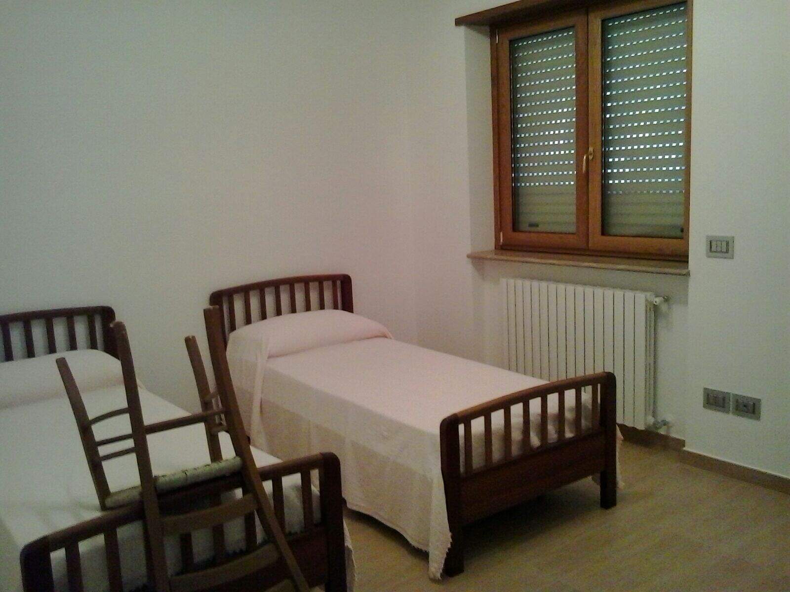 Interior view of a 3-bedroom house in Orsara di Puglia, Italy, with simple furnishings and a large w.