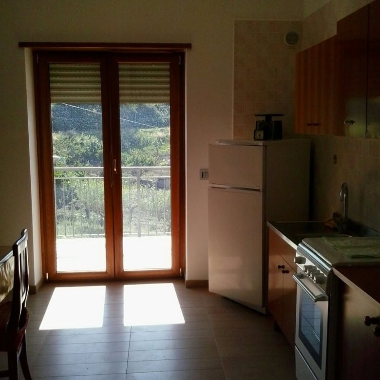 Bright kitchen with balcony view in Orsara di Puglia, Italy. Perfect for a comfortable home in a sce.