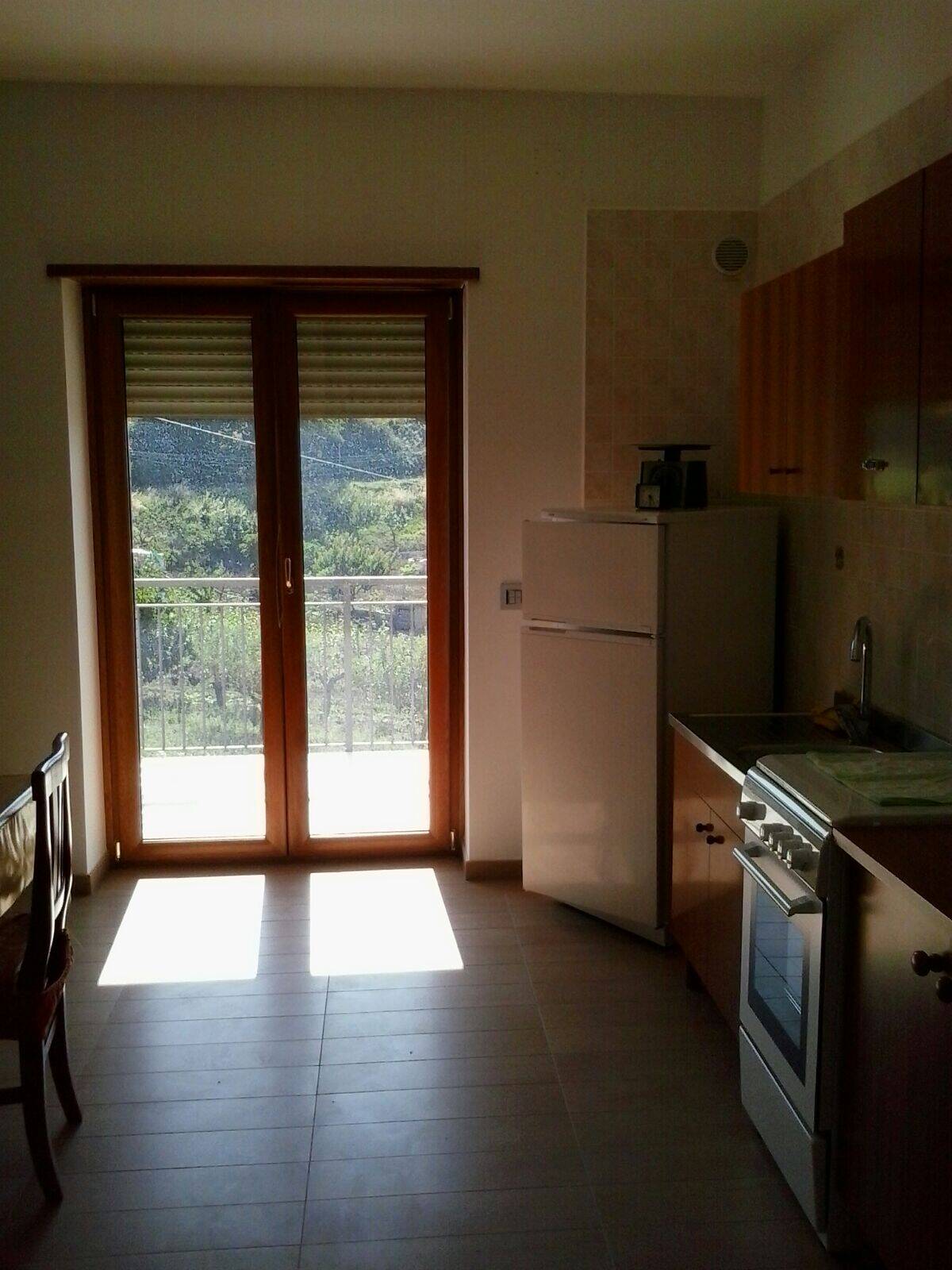 Bright kitchen with balcony view in Orsara di Puglia, Italy. Perfect for a comfortable home in a sce.