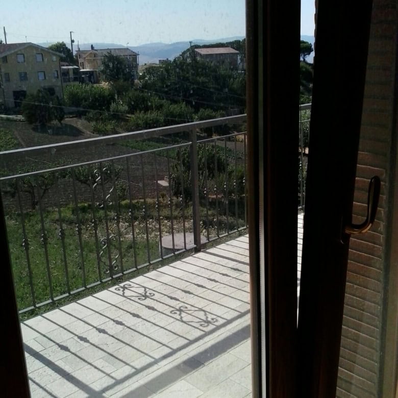 Bright view from balcony of a 3-bedroom house in Orsara di Puglia, Italy, with scenic countryside an.