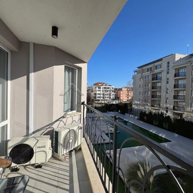 Balcony of a 2-bedroom apartment in J’adore Secret Garden, Sunny Beach, offering scenic urban vistas.