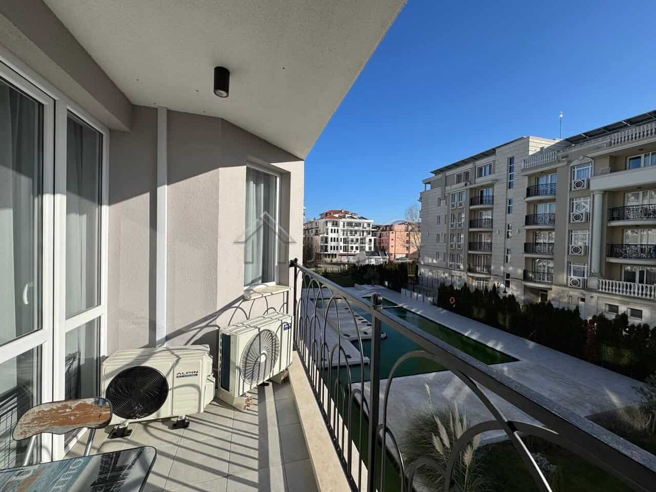 Balcony of a 2-bedroom apartment in J’adore Secret Garden, Sunny Beach, offering scenic urban vistas.