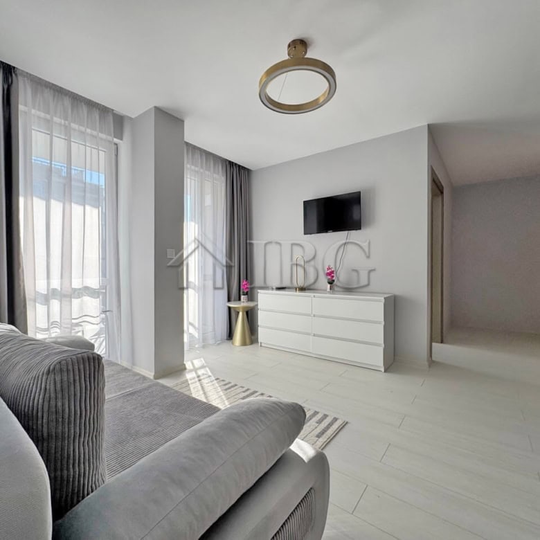 Bright living room with large windows and contemporary decor in J’adore Secret Garden.