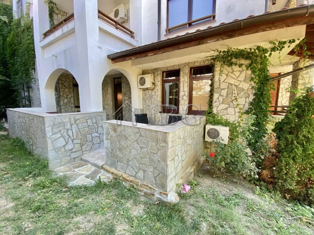 Exterior view of a spacious apartment with a large terrace and stone facade in Sveti Vlas.