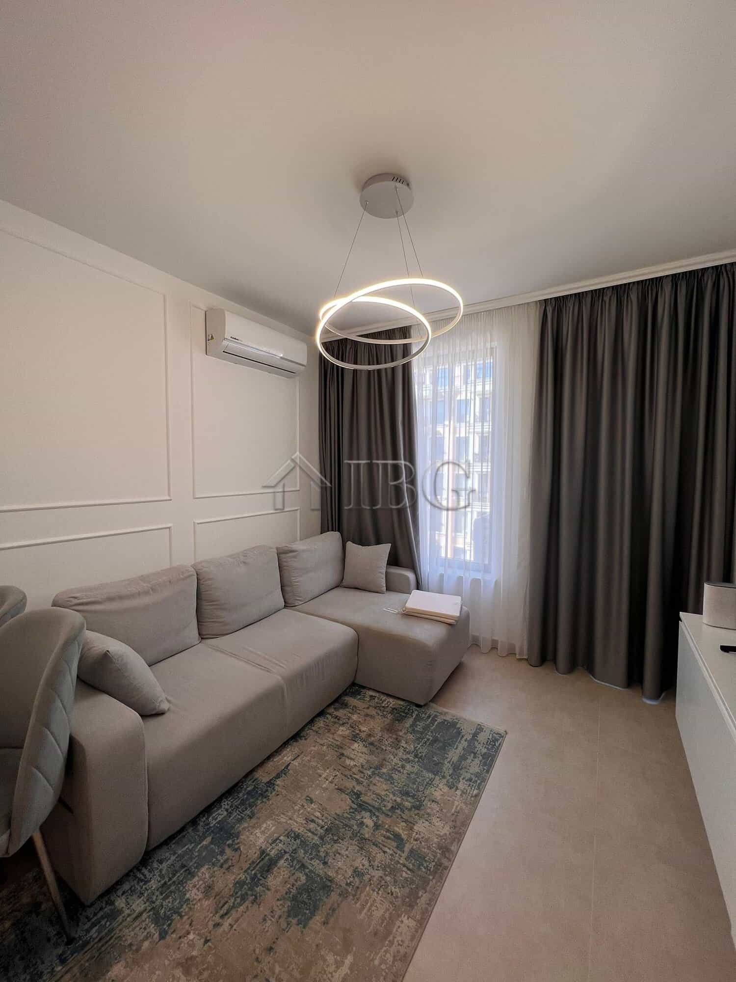 Cozy living room in a modern one-bedroom apartment with pool views at Polar Star, Sveti Vlas.