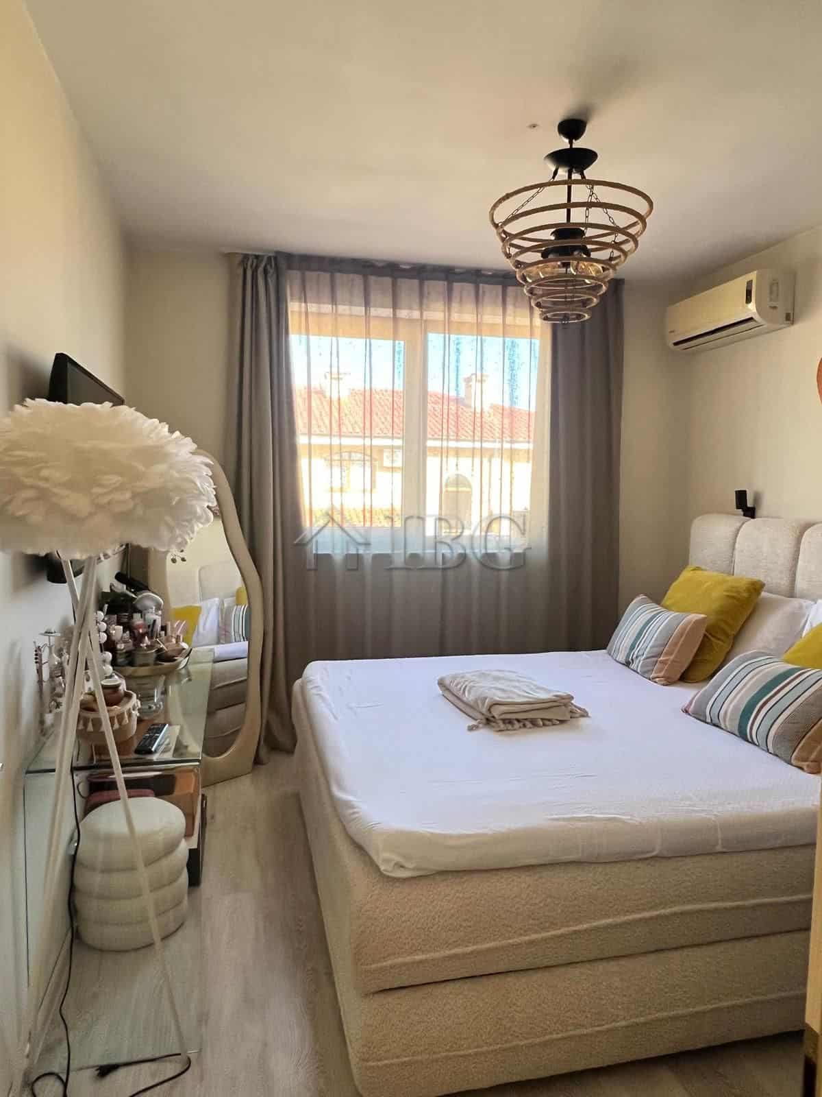 Bright bedroom with pool and partial sea view in Sveti Vlas apartment.