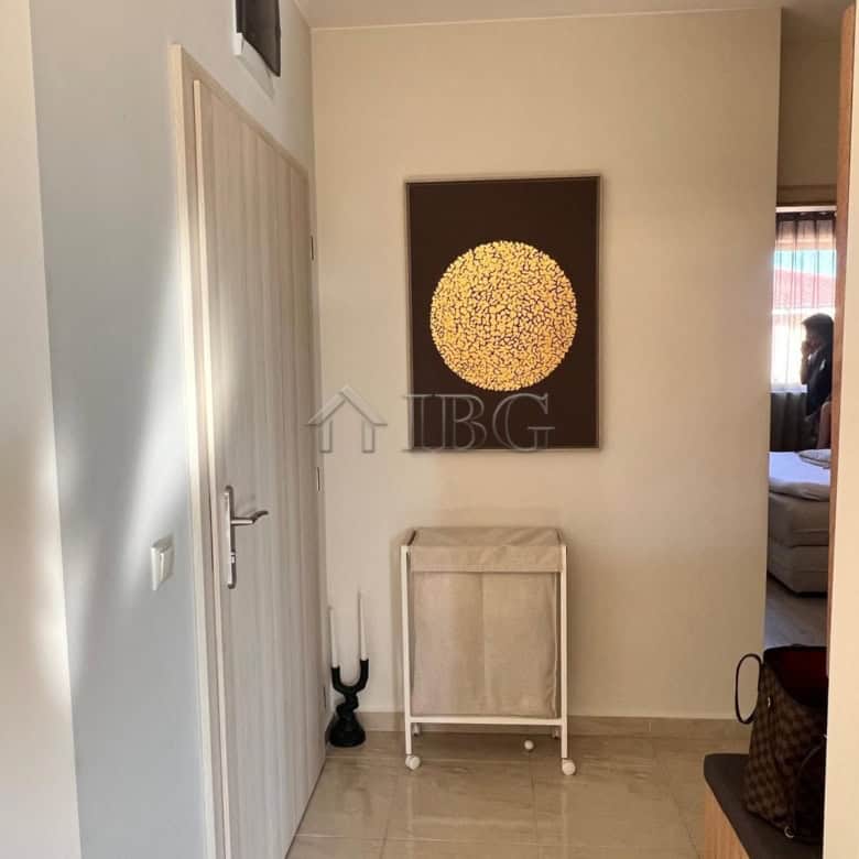 Bright apartment hallway with stylish wall art and minimalist furniture.