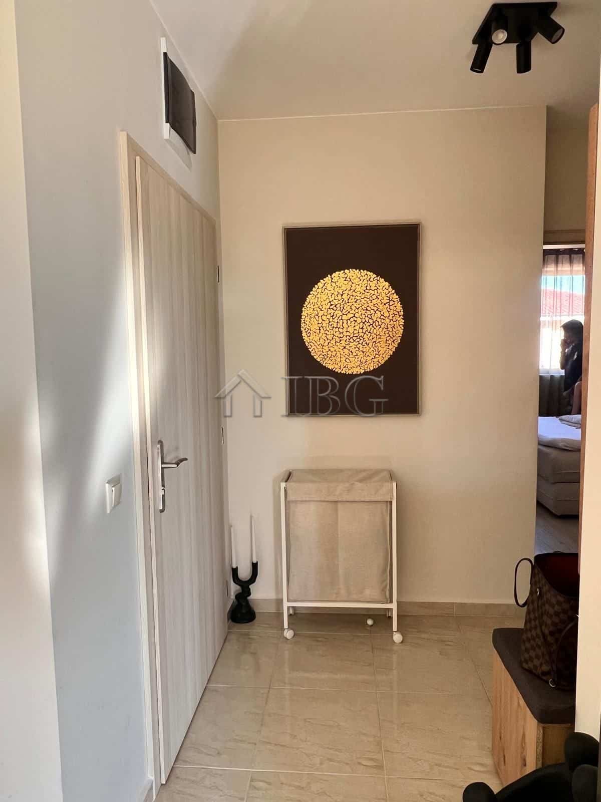 Bright apartment hallway with stylish wall art and minimalist furniture.