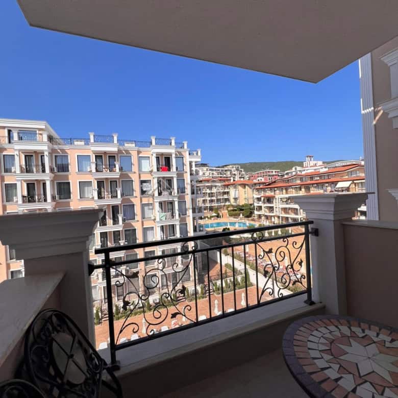 Balcony view of Sveti Vlas apartments and pool area from a modern one-bedroom apartment.