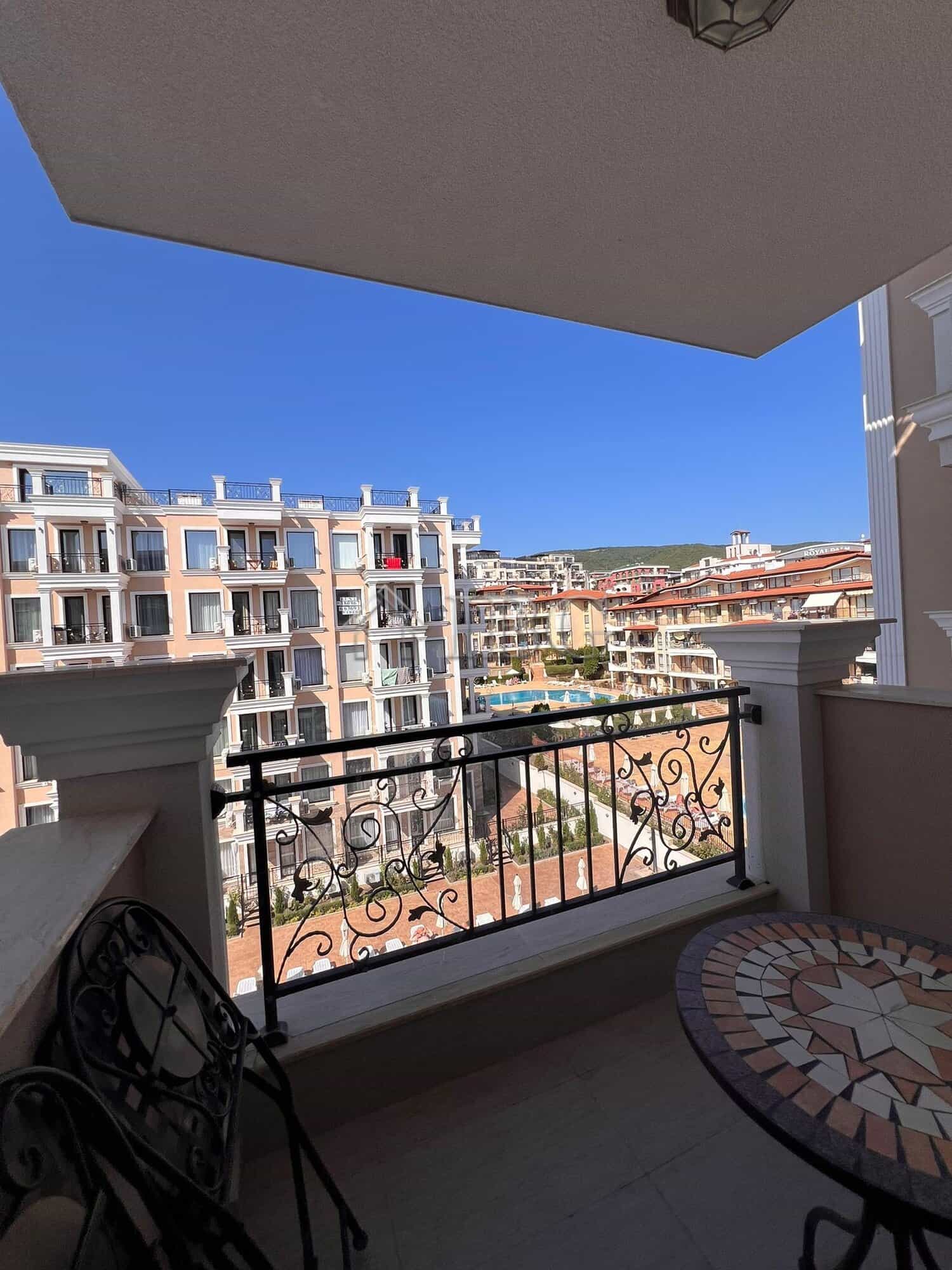 Balcony view of Sveti Vlas apartments and pool area from a modern one-bedroom apartment.