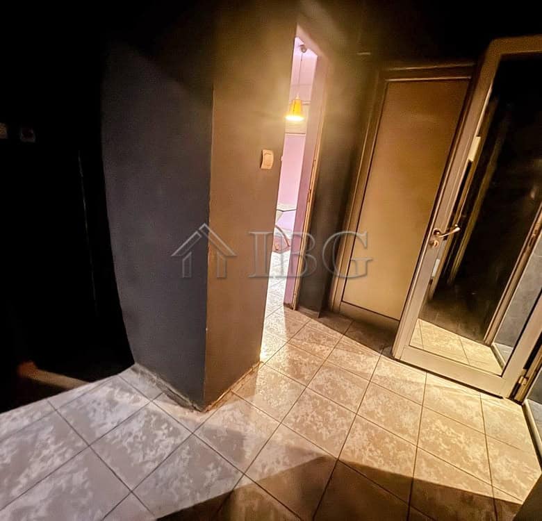 Modern commercial space with tiled flooring and glass door access.