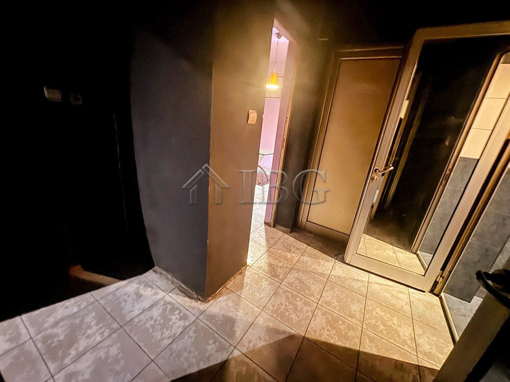 Modern commercial space with tiled flooring and glass door access.