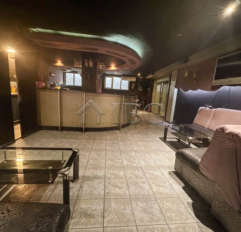 Commercial lounge with bar and seating for clients in a prime location.