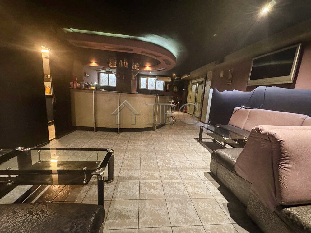 Commercial lounge with bar and seating for clients in a prime location.