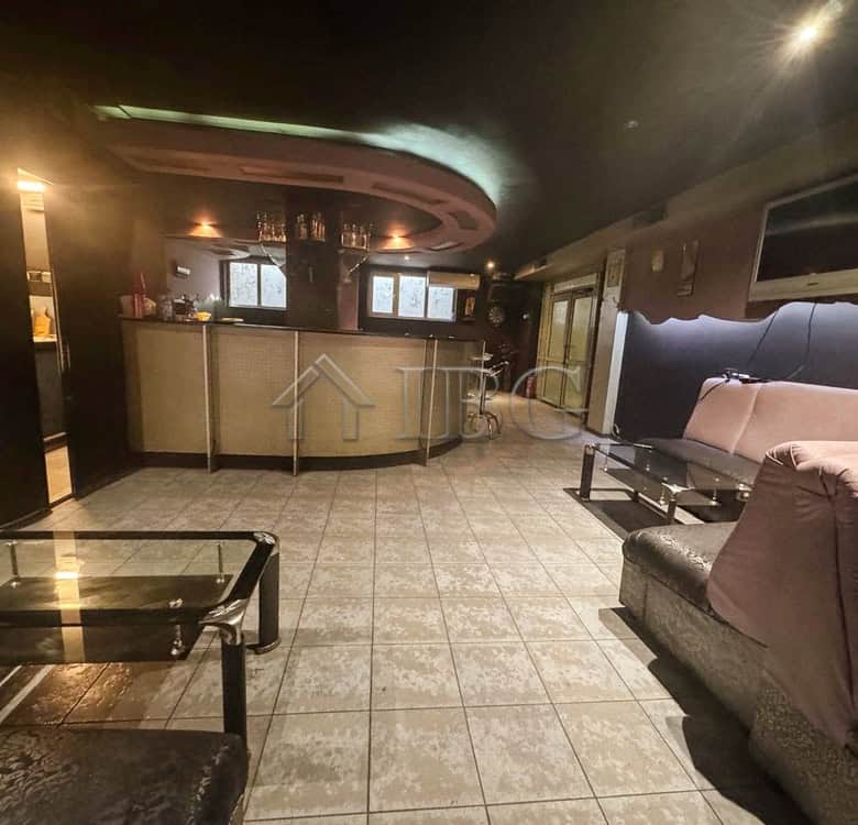 Commercial lounge with seating and bar for sale in prime location.