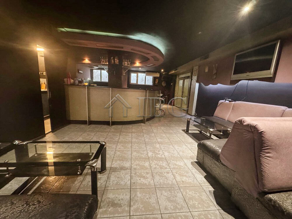 Commercial lounge with seating and bar for sale in prime location.