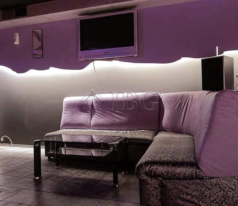 Spacious commercial space featuring a stylish lounge with purple seating and contemporary decor.