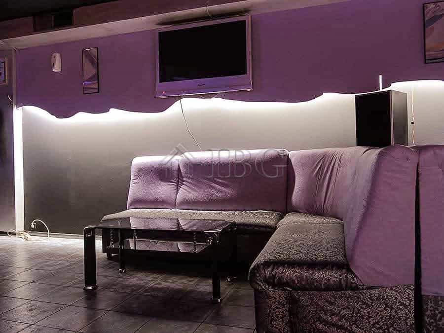 Spacious commercial space featuring a stylish lounge with purple seating and contemporary decor.