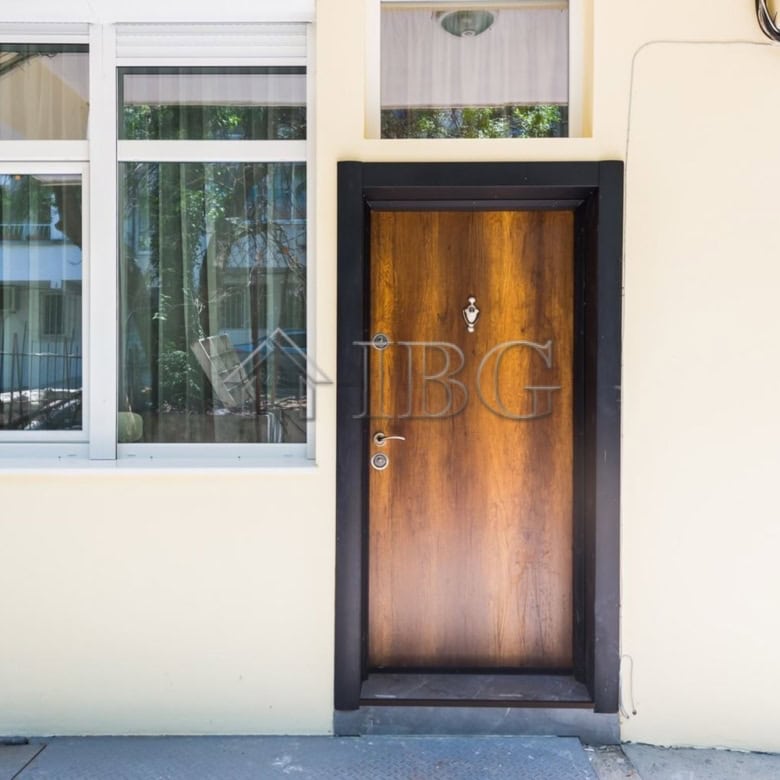 Entrance of a luxury 1-bedroom apartment with wooden door and large windows in Lazur District, Burga.