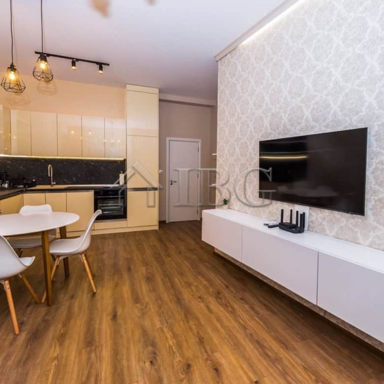 Spacious living area of a luxury 1-bedroom apartment with modern decor and a garage in Lazur Distric.