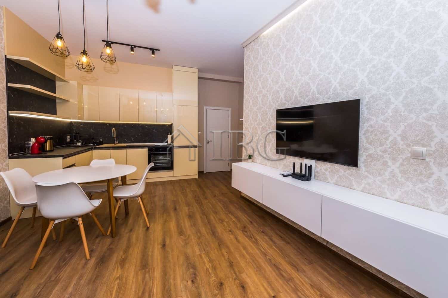 Spacious living area of a luxury 1-bedroom apartment with modern decor and a garage in Lazur Distric.