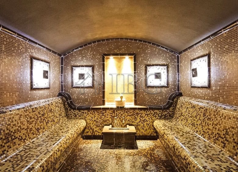 Elegant 1-bedroom apartment with mosaic tiled walls and cozy seating area near Balchik.